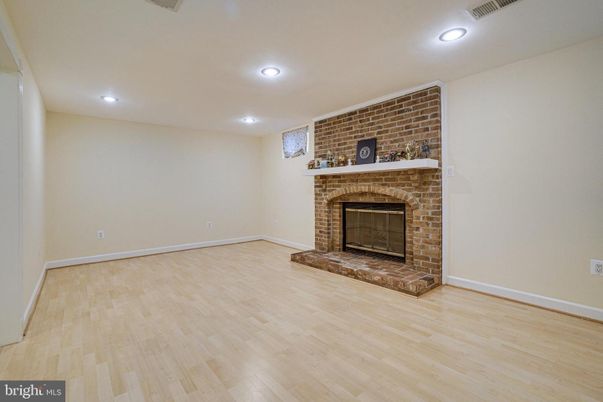 Empty room, Fireplace, Interior, Recessed Lighting, Stone Walls, Wood Texture Flooring