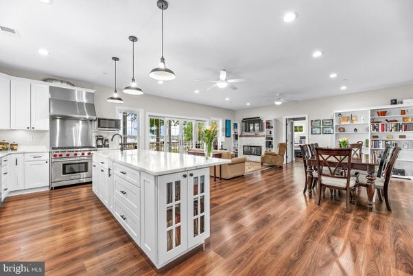 Dining room, Fireplace, Interior, Kitchen, Living room, Pendant Lights, Recessed Lighting, Stainless Steel Appliances, Wood Texture Flooring