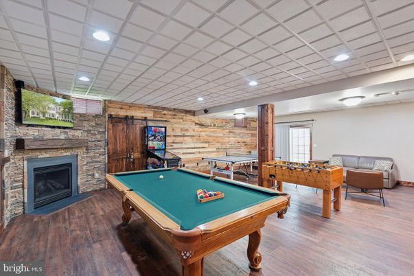 Billiard Table, Fireplace, Game Room, Interior, Recessed Lighting, Stone Walls, Wood Texture Flooring, Wooden Walls