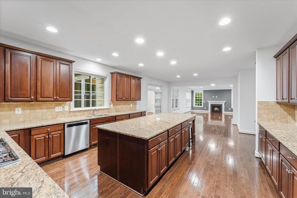 Fireplace, Interior, Kitchen, Recessed Lighting, Stainless Steel Appliances, Wood Texture Flooring