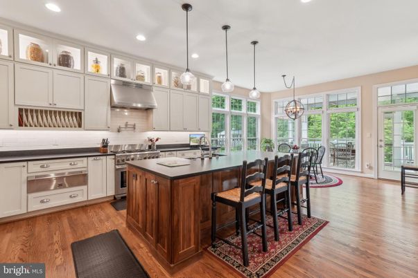 Chandelier, Dining room, Interior, Kitchen, Pendant Lights, Recessed Lighting, Stainless Steel Appliances, Wood Texture Flooring