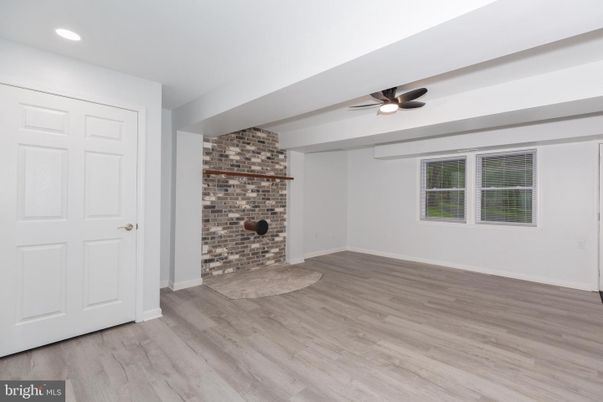 Empty room, Fireplace, Interior, Recessed Lighting, Stone Walls, Wood Texture Flooring