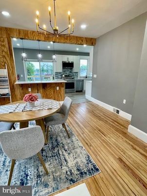 Chandelier, Dining room, Interior, Kitchen, Pendant Lights, Recessed Lighting, Stainless Steel Appliances, Wood Texture Flooring