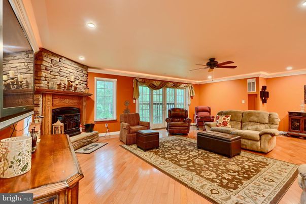 Fireplace, Interior, Living room, Recessed Lighting, Stone Walls, Wood Texture Flooring