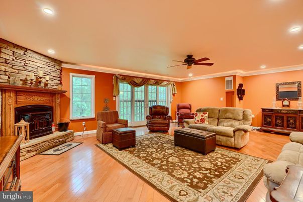 Fireplace, Interior, Living room, Recessed Lighting, Stone Walls, Wood Texture Flooring