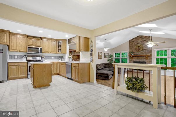 Fireplace, Interior, Kitchen, Recessed Lighting, Stainless Steel Appliances, Stone Walls, Wood Texture Flooring