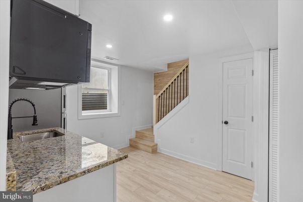 Interior, Kitchen, Recessed Lighting, Washer, Wood Texture Flooring