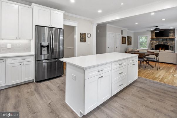 Dining room, Fireplace, Interior, Kitchen, Recessed Lighting, Stainless Steel Appliances, Wood Texture Flooring