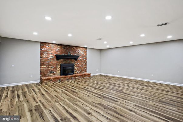 Empty room, Fireplace, Interior, Recessed Lighting, Stone Walls, Wood Texture Flooring