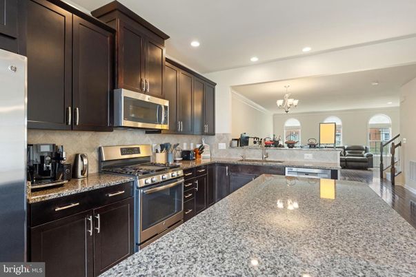 Chandelier, Interior, Kitchen, Living room, Recessed Lighting, Stainless Steel Appliances, Wood Texture Flooring