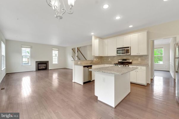 Chandelier, Fireplace, Interior, Kitchen, Recessed Lighting, Stainless Steel Appliances, Wood Texture Flooring