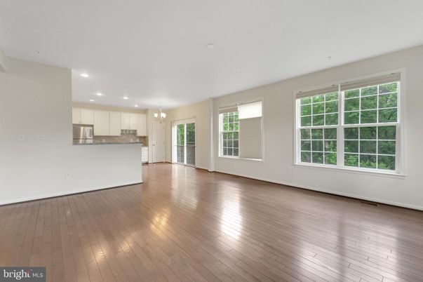 Chandelier, Empty room, Interior, Kitchen, Recessed Lighting, Stainless Steel Appliances, Wood Texture Flooring