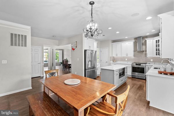 Chandelier, Dining room, Interior, Kitchen, Pendant Lights, Recessed Lighting, Stainless Steel Appliances, Wood Texture Flooring