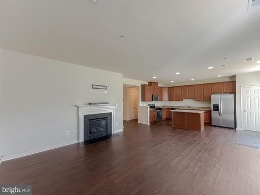 Empty room, Fireplace, Interior, Kitchen, Recessed Lighting, Stainless Steel Appliances, Wood Texture Flooring