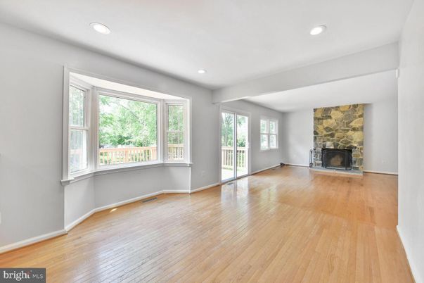 Empty room, Fireplace, Interior, Recessed Lighting, Stone Walls, Wood Texture Flooring