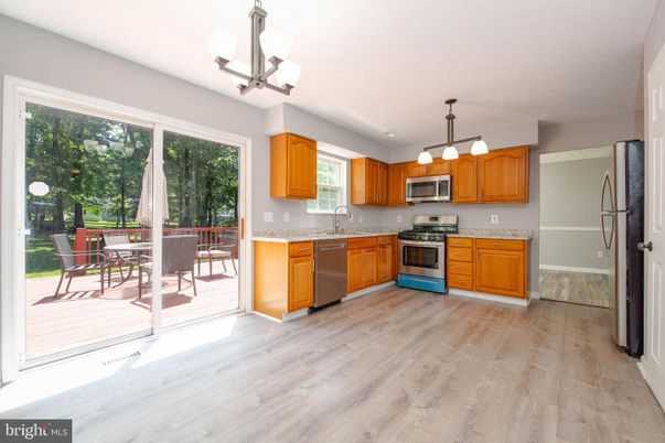 Chandelier, Dining room, Interior, Kitchen, Pendant Lights, Stainless Steel Appliances, Wood Texture Flooring