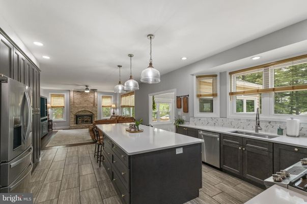Fireplace, Interior, Kitchen, Pendant Lights, Recessed Lighting, Stainless Steel Appliances, Stone Walls, Wood Texture Flooring
