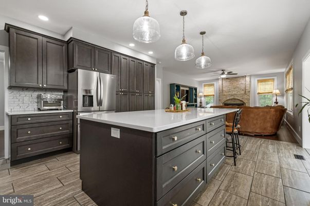 Fireplace, Interior, Kitchen, Pendant Lights, Recessed Lighting, Stainless Steel Appliances, Stone Walls, Wood Texture Flooring
