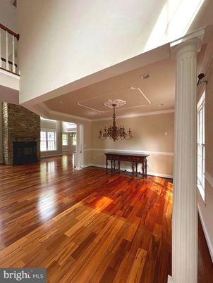 Chandelier, Fireplace, Interior, Recessed Lighting, Stone Walls, Wood Texture Flooring