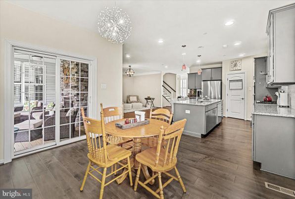 Chandelier, Dining room, Interior, Kitchen, Pendant Lights, Recessed Lighting, Stainless Steel Appliances, Wood Texture Flooring