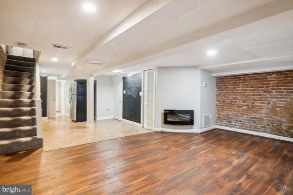 Empty room, Fireplace, Interior, Recessed Lighting, Stone Walls, Wood Texture Flooring