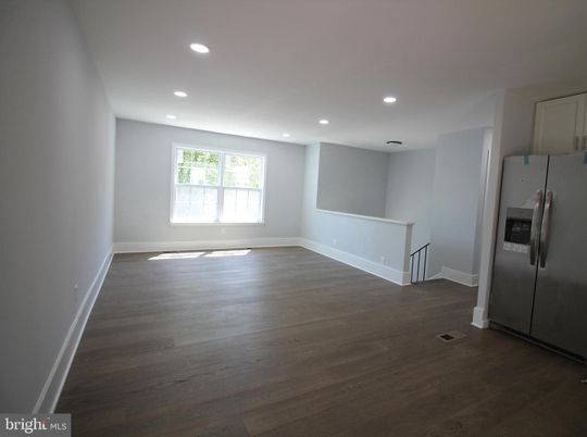 Empty room, Interior, Kitchen, Recessed Lighting, Stainless Steel Appliances, Wood Texture Flooring