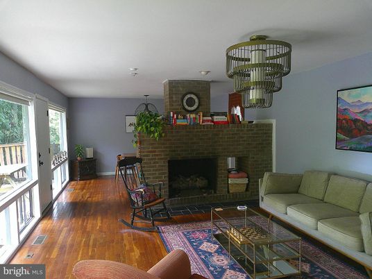 Chandelier, Dining room, Fireplace, Interior, Living room, Stone Walls, Wood Texture Flooring