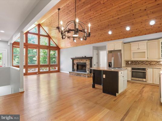 Chandelier, Empty room, Fireplace, Interior, Kitchen, Pendant Lights, Recessed Lighting, Stainless Steel Appliances, Wooden Ceilings, Wood Texture Flooring