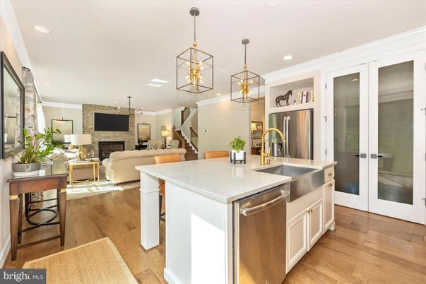Fireplace, Interior, Kitchen, Living room, Pendant Lights, Recessed Lighting, Stainless Steel Appliances, Stone Walls, Wood Texture Flooring