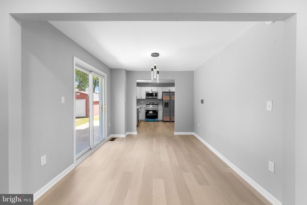 Empty room, Interior, Kitchen, Pendant Lights, Stainless Steel Appliances, Wood Texture Flooring