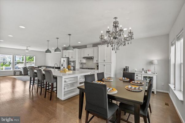 Chandelier, Dining room, Interior, Kitchen, Pendant Lights, Recessed Lighting, Stainless Steel Appliances, Wood Texture Flooring