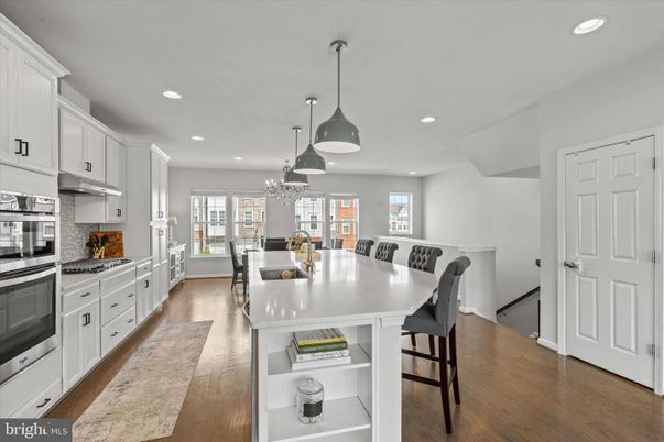 Chandelier, Dining room, Interior, Kitchen, Pendant Lights, Recessed Lighting, Stainless Steel Appliances, Wood Texture Flooring
