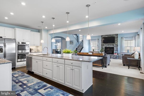 Fireplace, Interior, Kitchen, Living room, Pendant Lights, Recessed Lighting, Stainless Steel Appliances, Stone Walls, Wood Texture Flooring