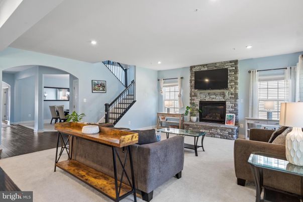 Dining room, Fireplace, Interior, Living room, Recessed Lighting, Stone Walls, Wood Texture Flooring