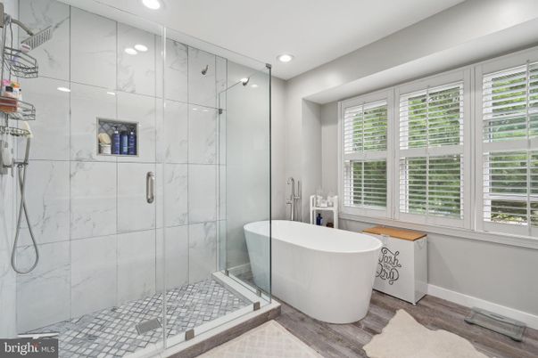 Bathroom, Free Standing Baths, Glass Shower, Interior, Marble Walls, Recessed Lighting, Wood Texture Flooring