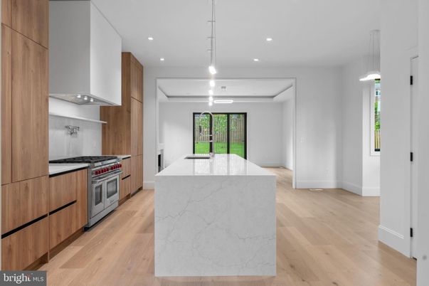 Interior, Kitchen, Marble Walls, Pendant Lights, Recessed Lighting, Stainless Steel Appliances, Wood Texture Flooring
