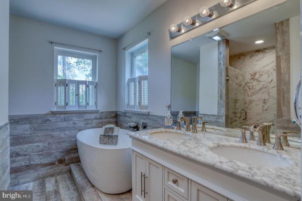 Bathroom, Dual Sink Vanities, Free Standing Baths, Interior, Marble Walls, Recessed Lighting, Wood Texture Flooring