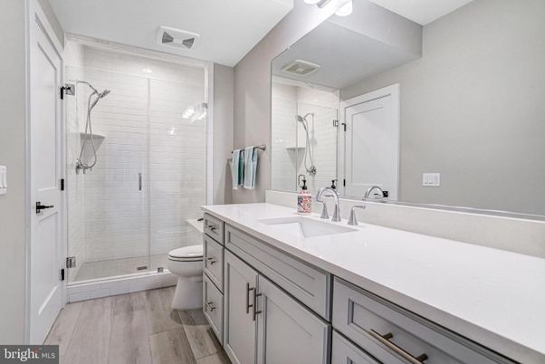 Bathroom, Dual Sink Vanities, Glass Shower, Interior, Recessed Lighting, Wood Texture Flooring