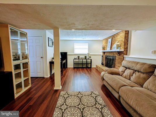 Fireplace, Interior, Living room, Recessed Lighting, Stone Walls, Wood Texture Flooring