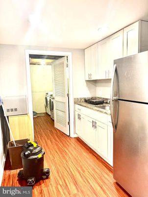 Interior, Kitchen, Recessed Lighting, Washer, Wood Texture Flooring