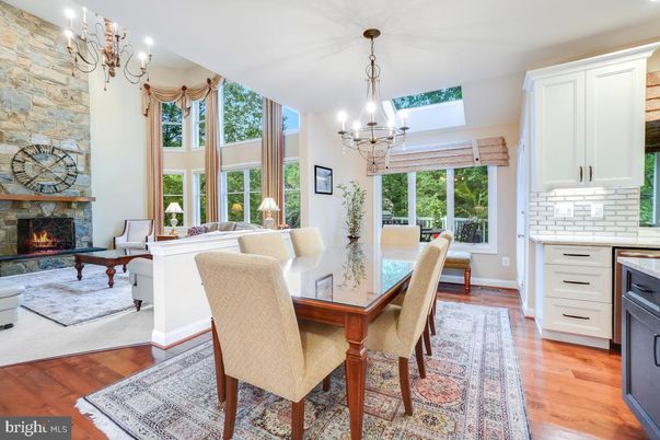 Chandelier, Dining room, Fireplace, Interior, Living room, Pendant Lights, Stone Walls, Wood Texture Flooring