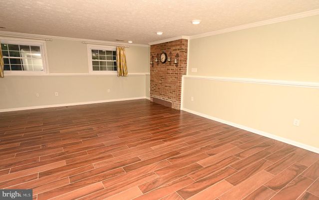 Empty room, Fireplace, Interior, Recessed Lighting, Stone Walls, Wood Texture Flooring