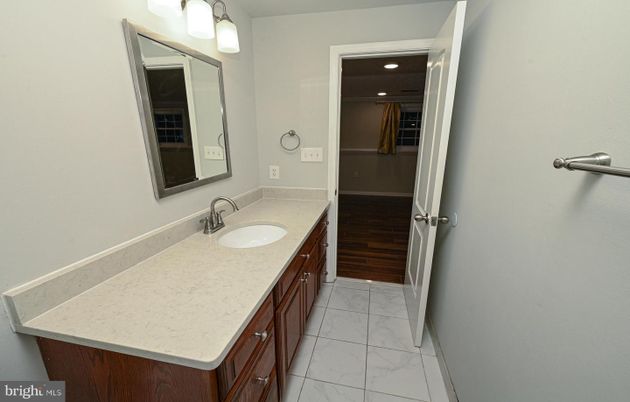 Bathroom, Dual Sink Vanities, Interior, Marble, Recessed Lighting, Wood Texture Flooring