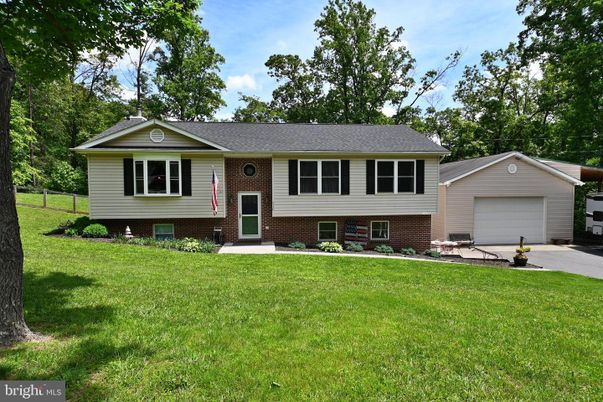 Attached, Backyard, Exterior, Facade, Brick Facade, Raised Ranch