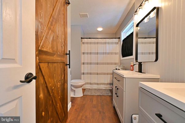 Bathroom, Dual Sink Vanities, Glass Shower, Interior, Recessed Lighting, Wood Texture Flooring