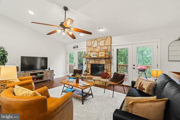 Fireplace, Interior, Living room, Recessed Lighting, Stone Walls, Wood Texture Flooring