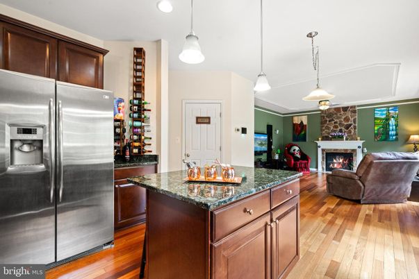 Fireplace, Interior, Kitchen, Living room, Pendant Lights, Recessed Lighting, Stainless Steel Appliances, Wood Texture Flooring