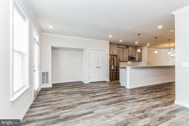 Empty room, Interior, Kitchen, Pendant Lights, Recessed Lighting, Stainless Steel Appliances, Wood Texture Flooring