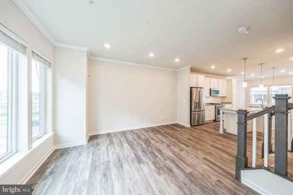 Empty room, Interior, Kitchen, Pendant Lights, Recessed Lighting, Stainless Steel Appliances, Wood Texture Flooring