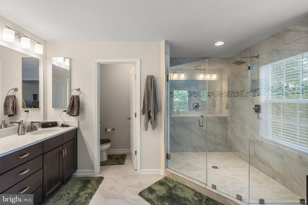 Bathroom, Dual Sink Vanities, Glass Shower, Interior, Marble, Marble Walls, Recessed Lighting